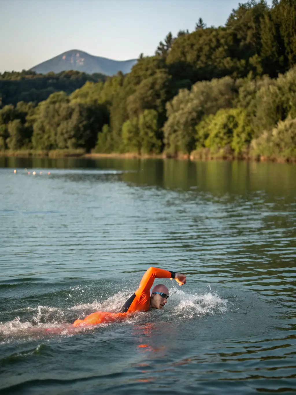 A high-energy image of a group of triathletes swimming in open water during a training session, showcasing the swimming component of the triathlon program offered by Millau Triathlon.
